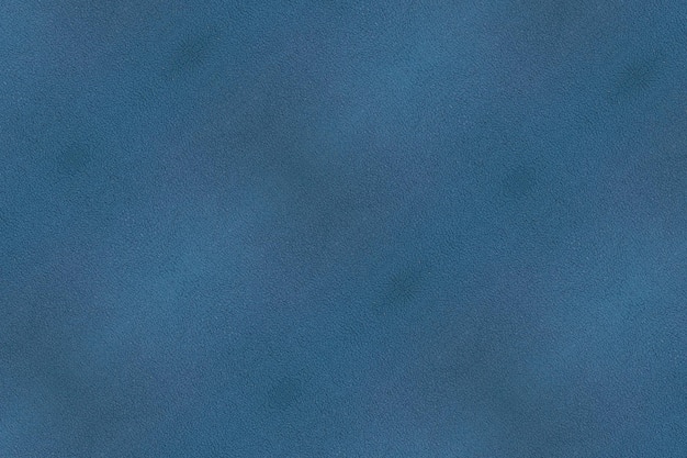 Tekstura niebieskiej, niejednolitej tkaniny bawełnianej z polaru