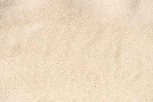 Tekstura piasku. Brązowy piasek. Tło z drobnego piasku. Obraz zbliżenia.