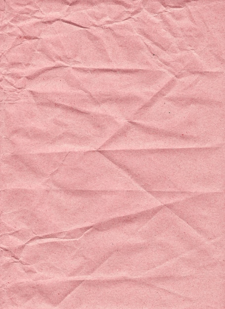 Tekstura różowego papieru z niechlujnymi zmarszczkami