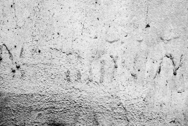 Tekstura, ściana, beton. Fragment ściany z rysami i pęknięciami