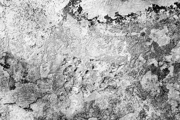 Tekstura ściany betonowej z pęknięciami i zarysowaniami w tle