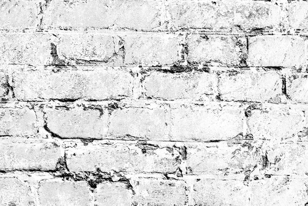 Tekstura ściany z cegły z pęknięciami i rysami, które można wykorzystać jako tło