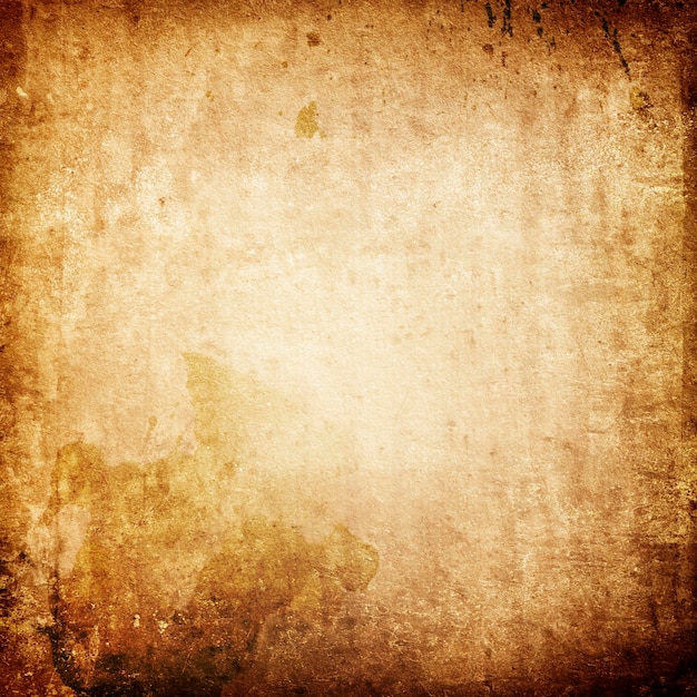 Zdjęcie tekstura starego brązowego papieru z zabytkowymi plamami i plamami oraz wyblakłym środkiem