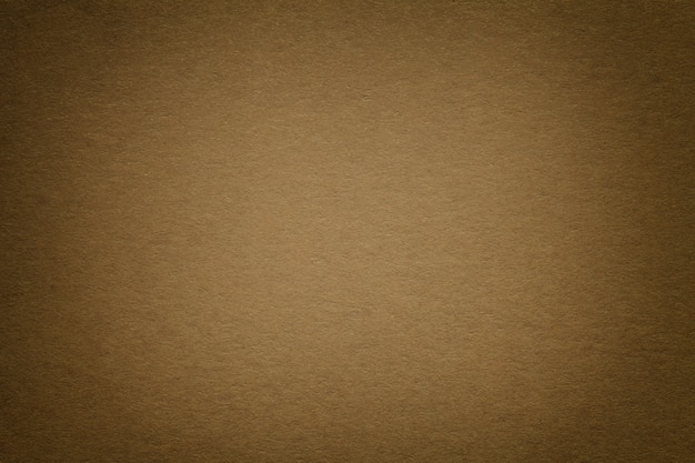 Zdjęcie tekstura stary ciemnego brązu papieru tło, zbliżenie. struktura gęstego kartonu.