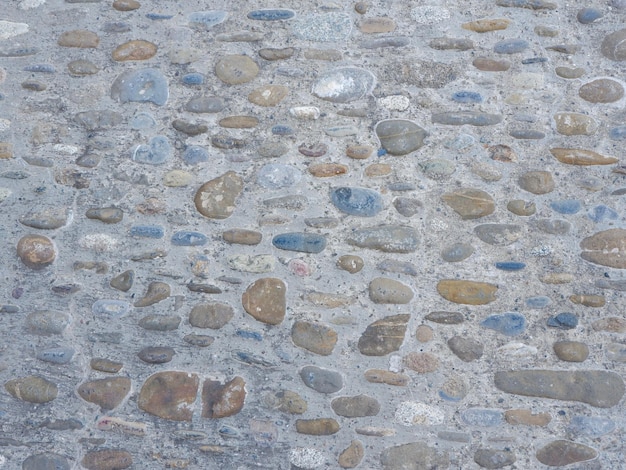 Tekstura wiejskiej ściany lub podłogi Owalny naturalny surowy kamień cementowy jako utrwalacz Tło dla tła i pustego