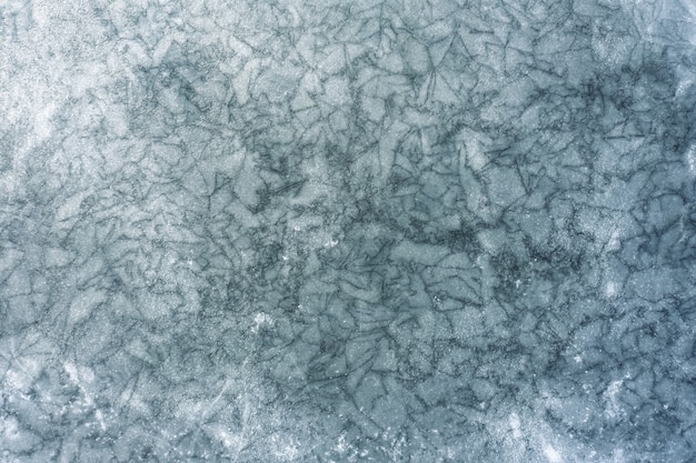 Zdjęcie tekstura zamarzniętego jeziora z dużą ilością pęknięć na powierzchni lodu