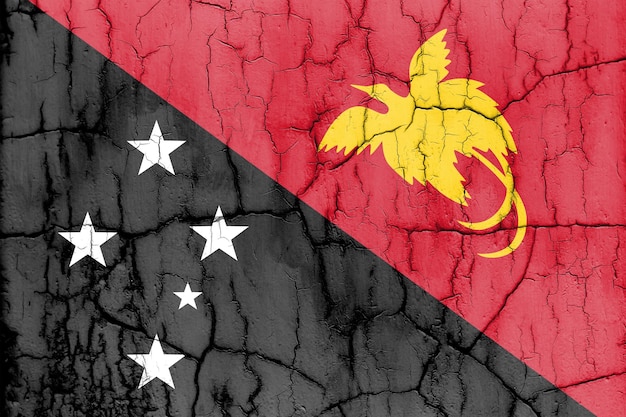 Teksturowane zdjęcie flagi Papui Nowej Gwinei z pęknięciami