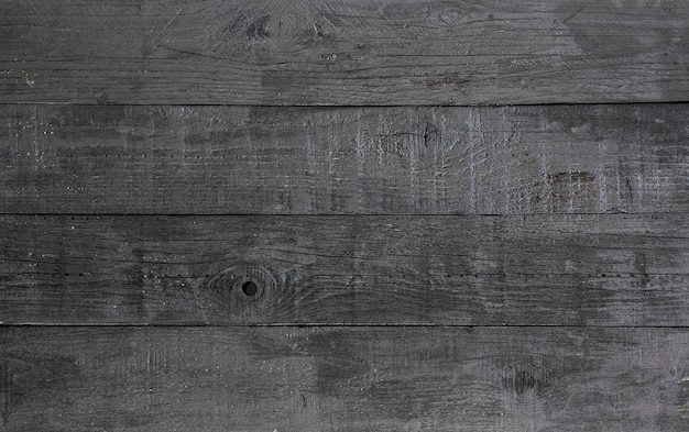tło i tekstura dekoracyjnej czarnej drewnianej ściany stodoły