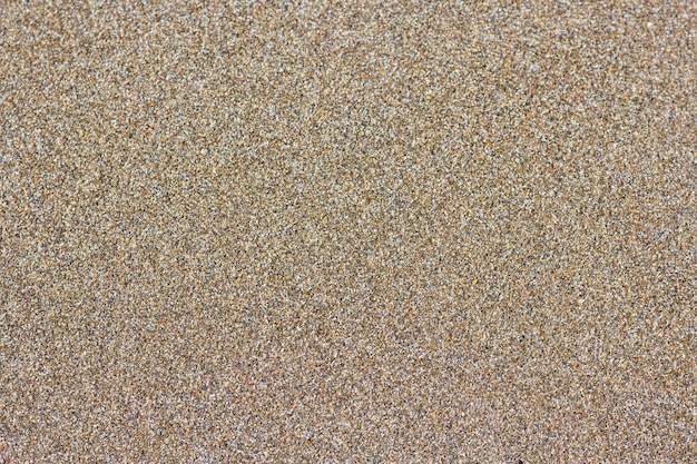 Tło piaszczystej plaży. Szczegółowa tekstura piasku, widok z góry
