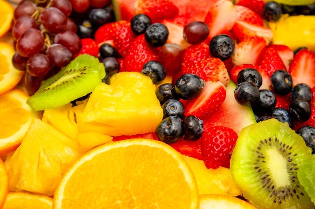 Tło świeżych owoców Zdrowa mieszanka owoców składa się z owoców tropikalnych i różnych jagód