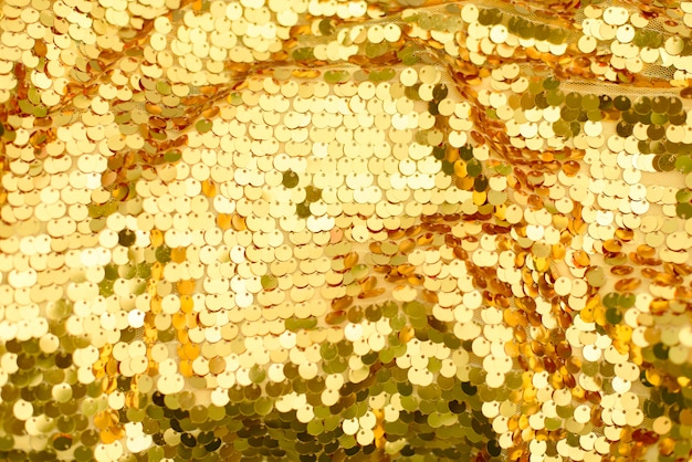 Tło z cekinów złote łuski. abstrakcyjny brokat