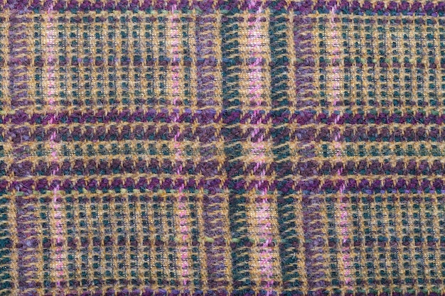 Zdjęcie tło z zielonej, brązowo-fioletowej wełnianej tkanki