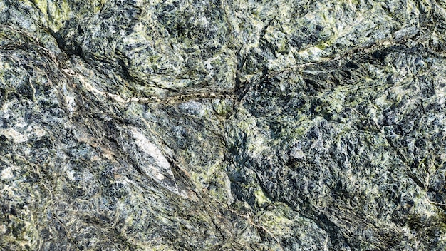 Tłoczona powierzchnia z teksturowanym kamiennym tłem. teksturowana powierzchnia naturalnej skały. faktura