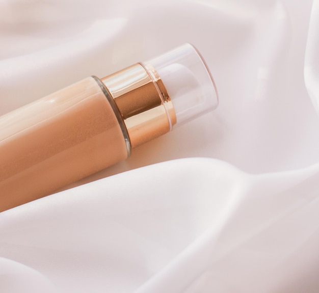 Tonalny krem bb butelka do makijażu podkład w płynie do nagiego koloru skóry na jedwabnym tle produkt kosmetyczny jako luksusowy projekt wakacyjny marki kosmetycznej