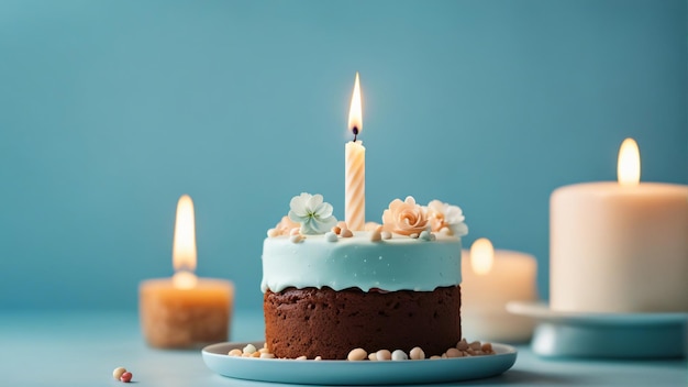 Tort urodzinowy ze świeczką na pastelowym niebieskim tle