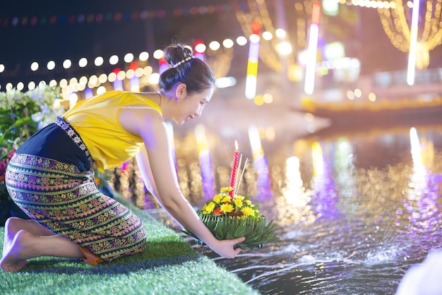 Tradycyjny festiwal Loy Krathong Piękna Tajka trzyma ozdobne liście bananowca w formie Krathong podczas uroczystości Loy Krathong w Tajlandii dla bogini wody w noc pełni księżyca