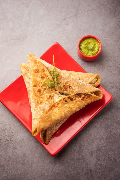 Triangle Paratha Wrap z nadzieniem ziemniaczanym z kurczaka podawany z zielonym chutney, indyjskie jedzenie