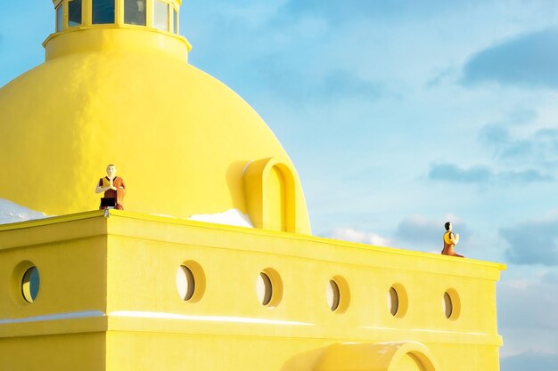 Zdjęcie tybetańska żółta stupa z modlącymi się mnichami, koncepcja minimalizmu, święty budynek w kulturze azjatyckiej