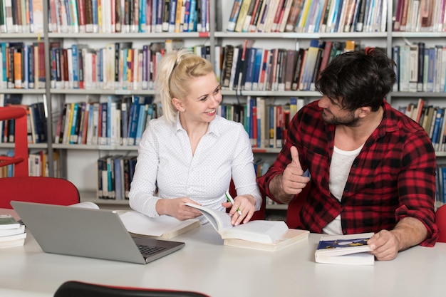 Zdjęcie uczniowie przygotowujący egzamin i lekcje w szkolnej bibliotece dokonywanie badań na laptopie i przeglądanie internetu w bibliotece