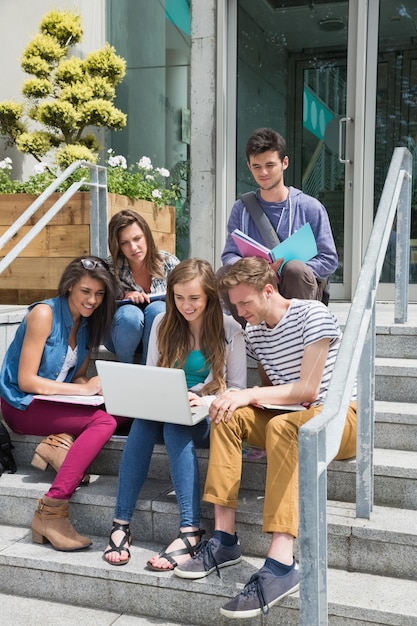 Uczniowie siedzący na schodach studiujący na uniwersytecie