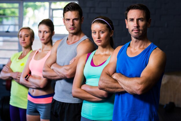 Ufne męskie i żeńskie atlety stoi w gym