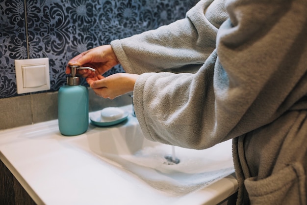 Zdjęcie upraw kobiety dolewanie mydło na ręce