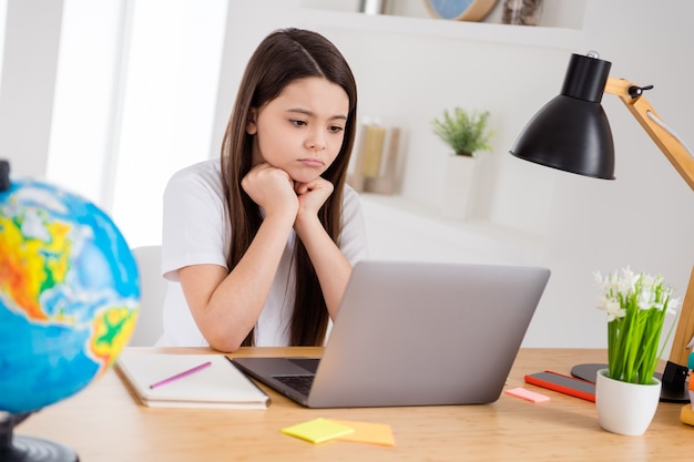 urocza mała uczennica zdalna nauka na odległość w domu wirtualny laptop nauka