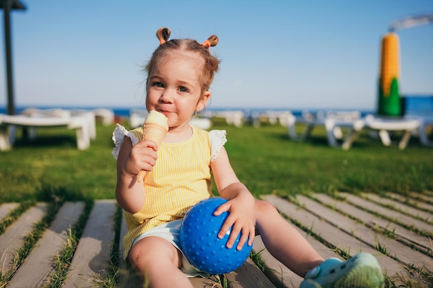 Urocza maluch dziewczyna je lody na zewnątrz