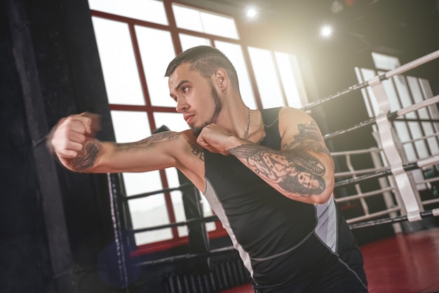 Urodzony, by walczyć z silnym mężczyzną w bokserskiej odzieży sportowej z pewnym cieniem atletą rzucającym hakiem