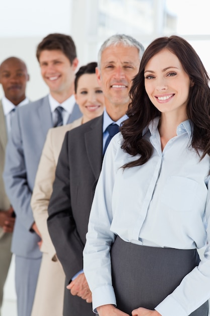 Uśmiechnięty bizneswoman patrzeje ufny podczas gdy podążać jej współpracownikami