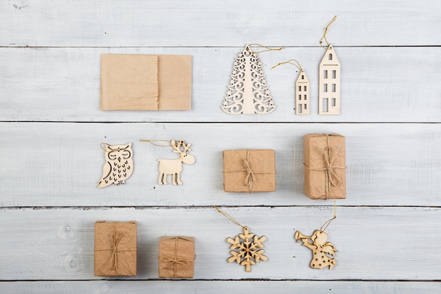 Vintage świąteczne dekoracje na drewnianym stole pudełka na prezenty płatki śniegu anioł jeleń dom drzewo itp