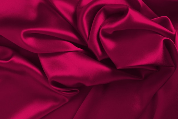 Viva magenta jedwabna lub satynowa luksusowa tekstura tkaniny może służyć jako abstrakcyjne tło