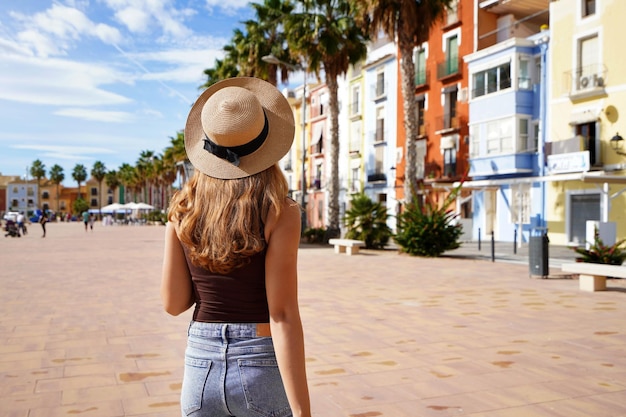 Wakacje w Europie Szczęśliwa podróżniczka odwiedzająca kolorową hiszpańską wioskę z palmami i plażami Villajoyosa Alicante Hiszpania Skopiuj miejsce