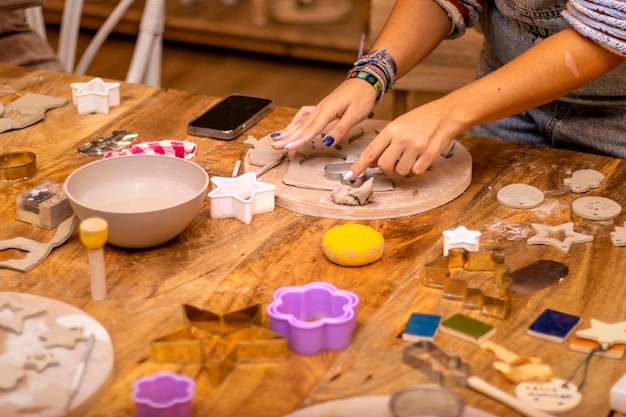 Zdjęcie warsztat ceramiczny młoda dziewczyna zajmuje się ceramiką za pomocą foremek