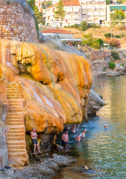 Wczasowicze biorą naturalne lecznicze kąpiele w gorących źródłach w uzdrowisku Loutra Edipsou w Grecji