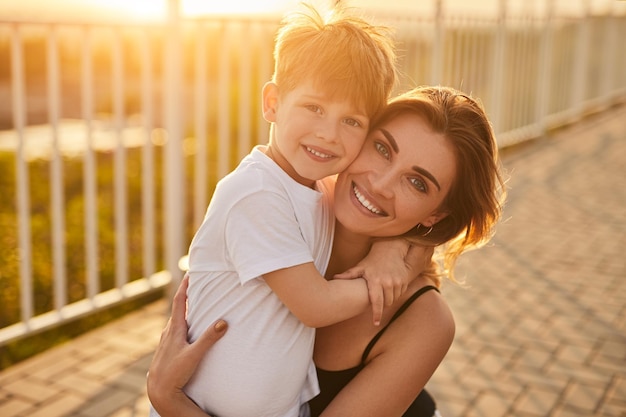 Wesoła Mama I Syn W Objęciach Na Moście