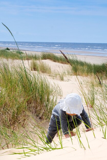 Zdjęcie wesoła, urocza dziewczynka na plaży.