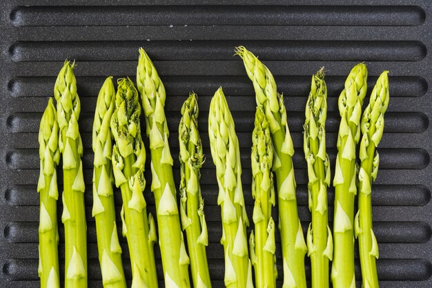 Wiązka zielony asparagus na czarnej niecce