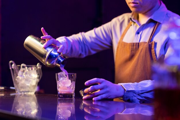 Widok boczny barman przygotowujący napój