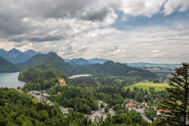 Zdjęcie widok na zamek hohenschwangau, xix-wieczny pałac i alpsee w pobliżu miasta fussen niemcy