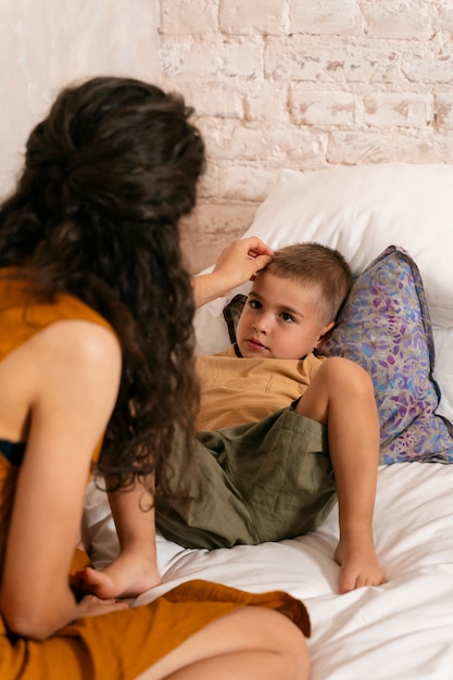 Zdjęcie widok z boku kobiety i dziecka w łóżku