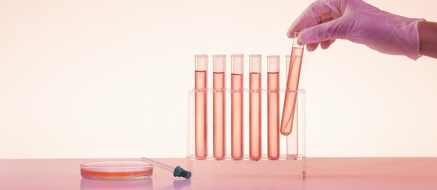 Widok z boku ręki trzymającej rurkę w laboratorium