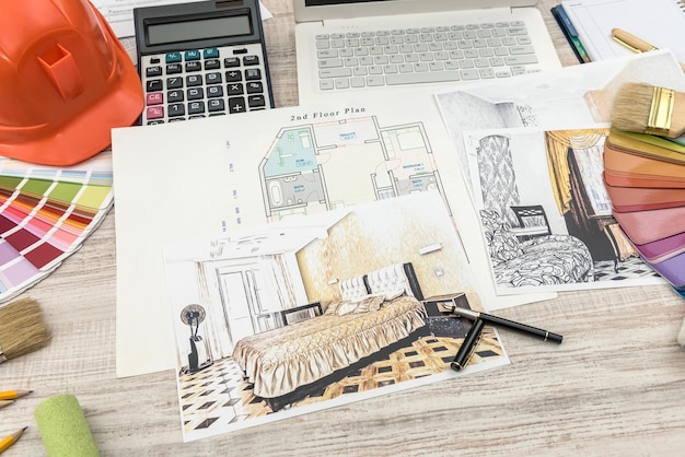 Zdjęcie widok z góry na architektów rysujących nowoczesny dom z przykładowym materiałem, kaskiem, laptopem na kreatywnym stole
