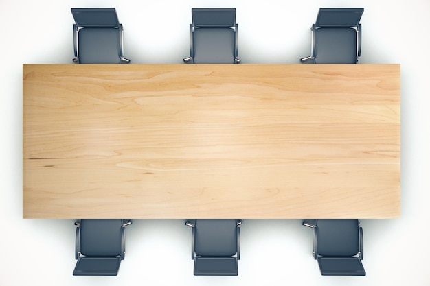 Widok z góry na drewniany stół konferencyjny i czarne krzesła
