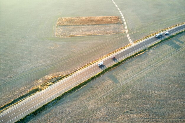 Widok z lotu ptaka drogi międzymiastowej z szybkimi samochodami o zachodzie słońca Widok z góry z drona ruchu autostradowego wieczorem