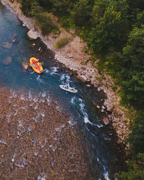 Zdjęcie widok z lotu ptaka górskiej rzeki ludzi rafting w potoku. ekstremalna witalność