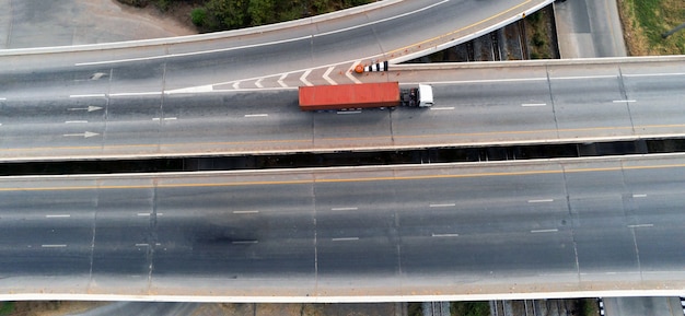 Zdjęcie widok z lotu ptaka na ładunek biały ciężarówka na autostradzie z zielonym pojemnikiem, koncepcja transportu, import, eksport logistyka przemysłowa transport transport lądowy na asfaltowej drodze ekspresowej