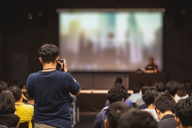 Widok Z Tyłu Fotografa Robiącego Zdjęcie Azjatyckiego Mówcy Rozmawiającego Na Scenie Podczas Seminarium