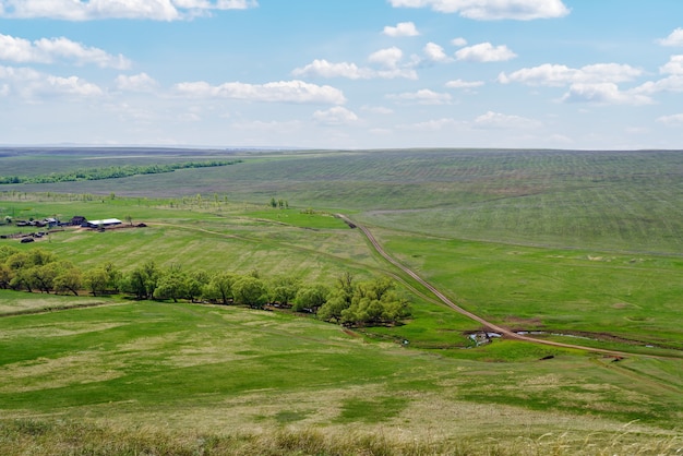 Wiosenny wiejski krajobraz z polami uprawnymi i polną drogą w pobliżu wsi Voskresenovka Rosja