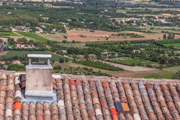 Wioska Gordes i widok na dolinę Luberon z polami, zielonymi drzewami i farmami Vaucluse Provence